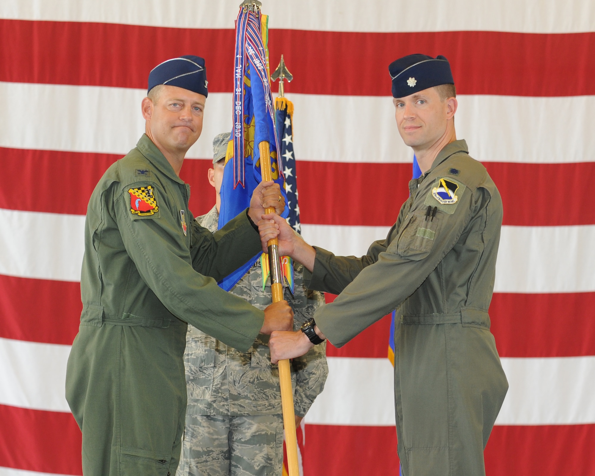 Colonel Max Marosko, 325th Operations Group commander, passes the 43rd Fighter Squadron guidon to Lt. Col. William Creeden who assumed command of the 43rd FS in a change of command ceremony July 11. (U.S. Air Force photo by Airman 1st Class Alex Echols)