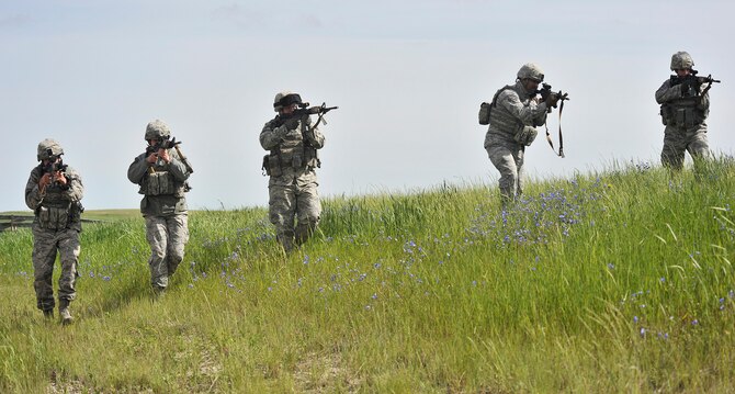 Members of the 341st Missile Security Forces Squadron demonstrate a sweep June 12 near Judith Gap, Mont. Pictured from left to right are: Senior Airman Matthew Roether, Airman 1st Class Bethany Zupkow; Airman 1st Class Samuel Earney; Senior Airman Grant Gipson; and Staff Sgt. Darby Rochleau. (U.S. Air Force photo/John Turner)