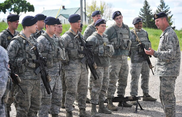 Maj. Justin Secrest, 341st Missile Security Forces Squadron commander (right), talks with members of the squadron’s Charlie flight June 12 in Judith Gap, Mont. The flight was providing security support during the wing codes change program in the 490th Missile Squadron area. (U.S. Air Force photo / John Turner)