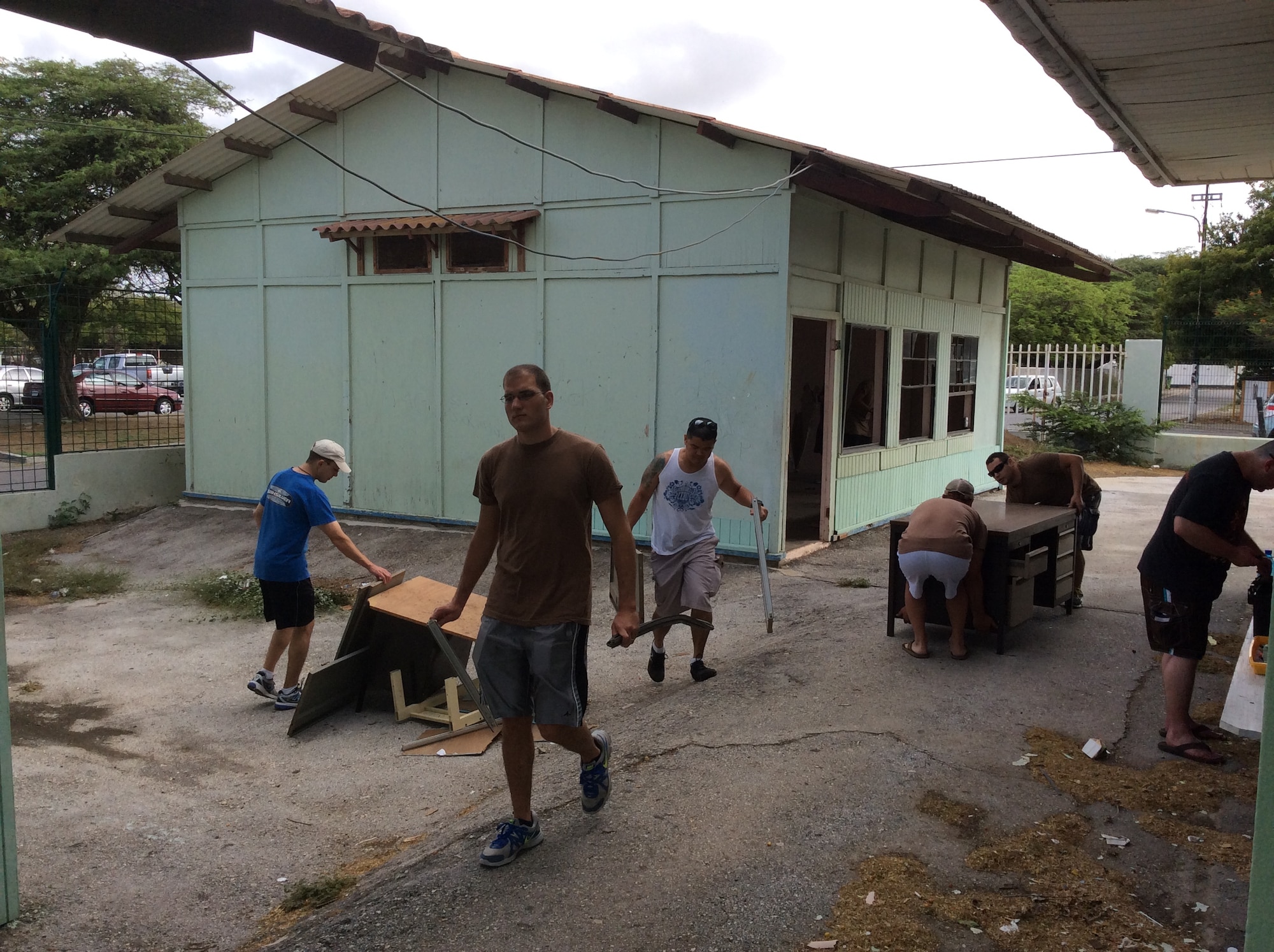 Volunteers from the U.S. Forward Operating Location spent several hours refurbishing classrooms for students at Goslinga School in Otrabanda, Curacao, July 8, 2014.  Twenty-nine volunteers landscaped, moved furniture, installed windows and reconstructed damaged facilities. The aim of the project was to refurbish two classrooms to create vibrant, spacious, safe and effective learning environments in preparation for the upcoming school year. Volunteers from the US FOL donate time and resources to various areas and programs on the island in order to express appreciation for the wonderful hospitality received from the citizens of Curacao. (Courtesy Photo) 