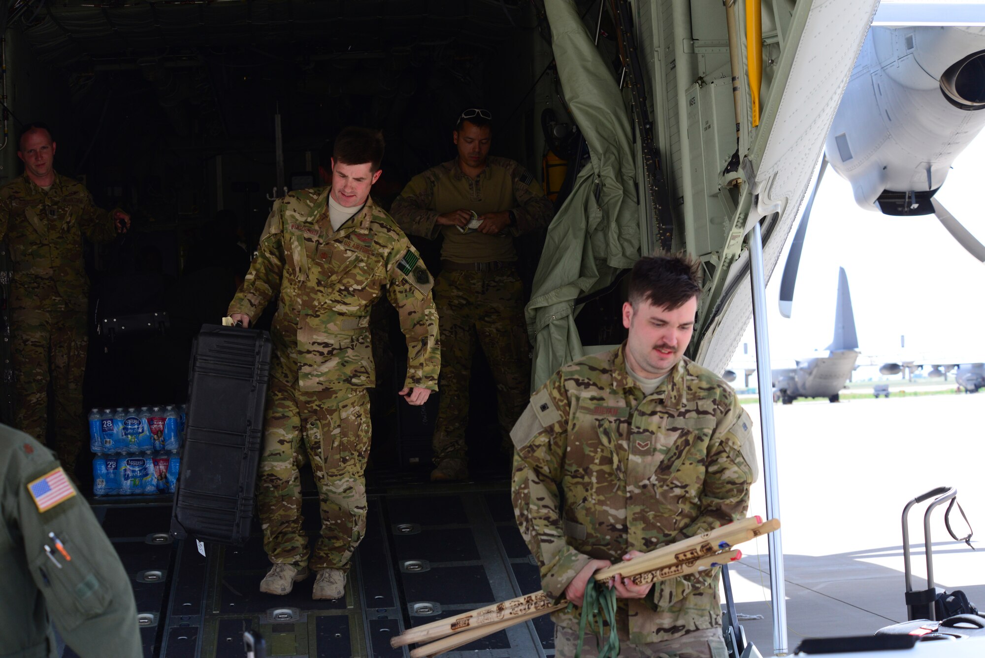 Aircrew from the 522nd Special Operations Squadron unload supplies, souvenirs, and luggage down the ramp of an MC-130J Commando II that just completed a mission around the globe July 9, 2014 at Cannon Air Force Base, N.M. The mission spanned five continents and took nearly four weeks to complete. 