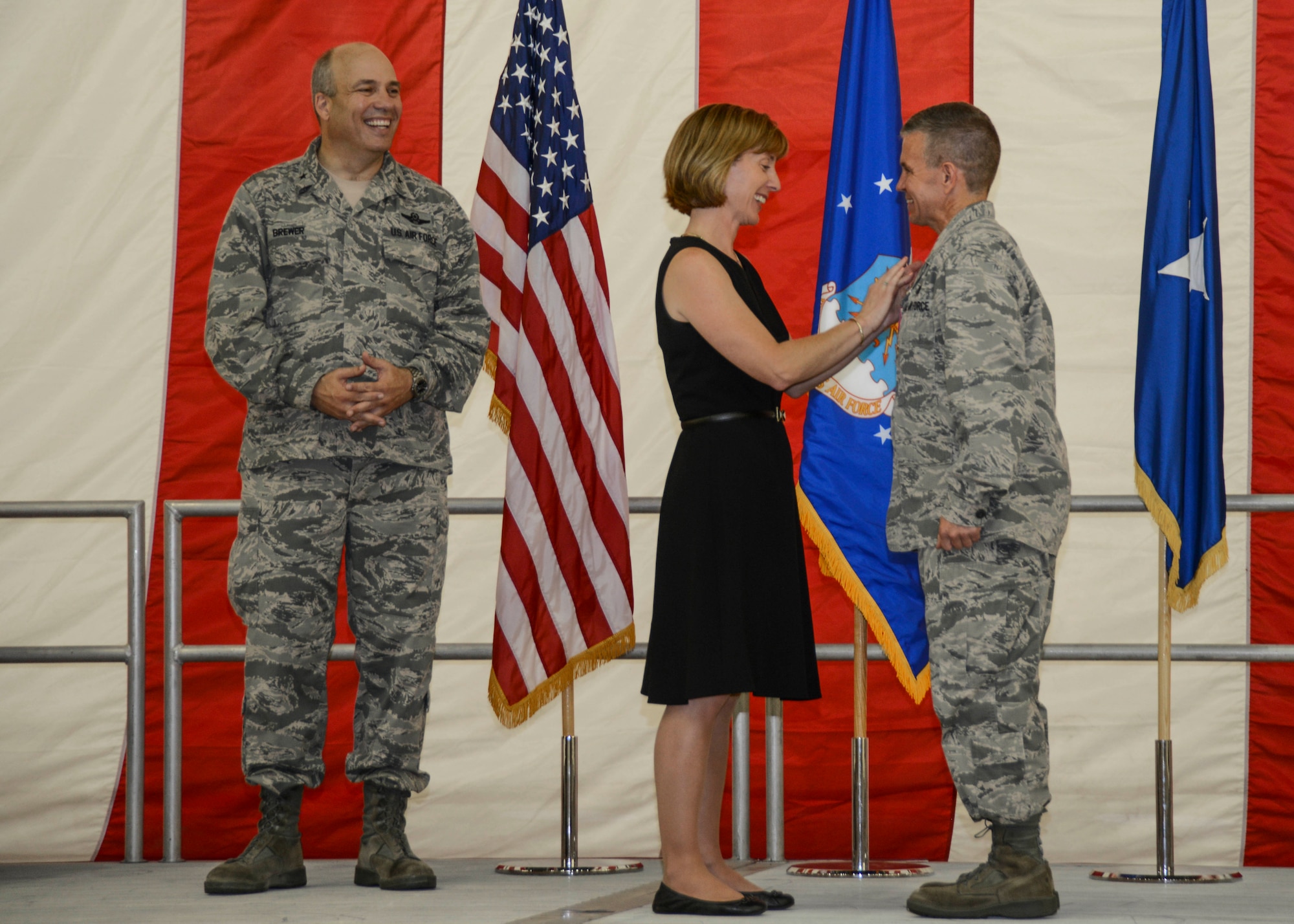 Outgoing commander of the 412th Maintenance Group, Col. Robby Weaver (right) receives his retirement pin from his wife Susan during Weaver’s retirement ceremony July 10. Weaver and his wife are retiring after a 25-year career in the Air Force; the last three of which were spent as the 412th MXG commander at Edwards AFB. (U.S. Air Force photo by Rebecca Amber) 