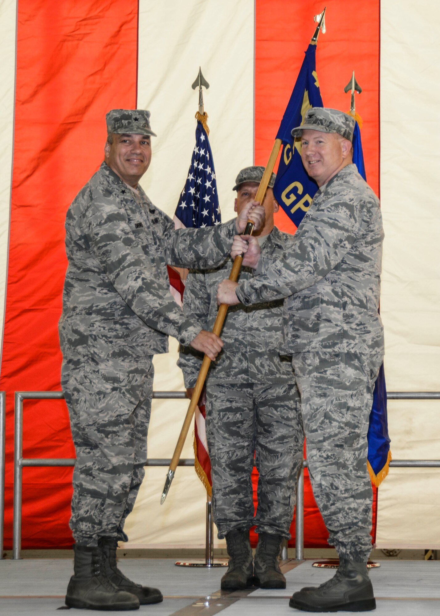 Brig. Gen. Michael Brewer (left) 412th Test Wing commander, hands the 412th Maintenance Group ceremonial guidon to Col. Robert Lepper to symbolize the official start of his new role as group commander, during a change of command ceremony July 10. (U.S. Air Force photo by Rebecca Amber) 