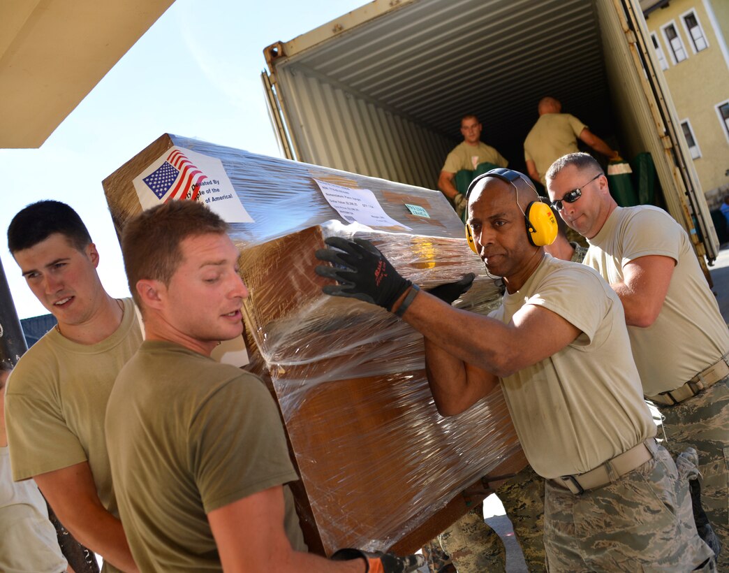 U.S. Air Force Airmen from the 133rd and 148th Civil Engineering Squadron and 219th Red Horse Squadron in partnership with the Croatian Army unload school supplies at an elementary school in Ogulin, Croatia, July 3, 2014. The school supplies were donated from school closures in Germany, base closures at U.S. Army installations in Europe and other various locations. (U.S. Air National Guard photo by Staff Sgt. Austen Adriaens/Released)