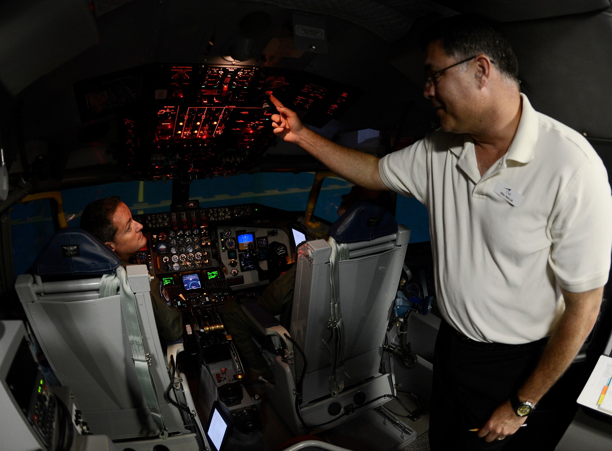 Mike Kirkner, Canadian Aviation Electronics representative, conducts a simulation training July 10, 2014 at MacDill Air Force Base, Fla. Pilots from the 63rd Air Refueling Squadron received windshear training to ensure that they are familiar with procedures during windshear conditions.(U.S. Air Force photo by Senior Airman Jenay Randolph/Released) 