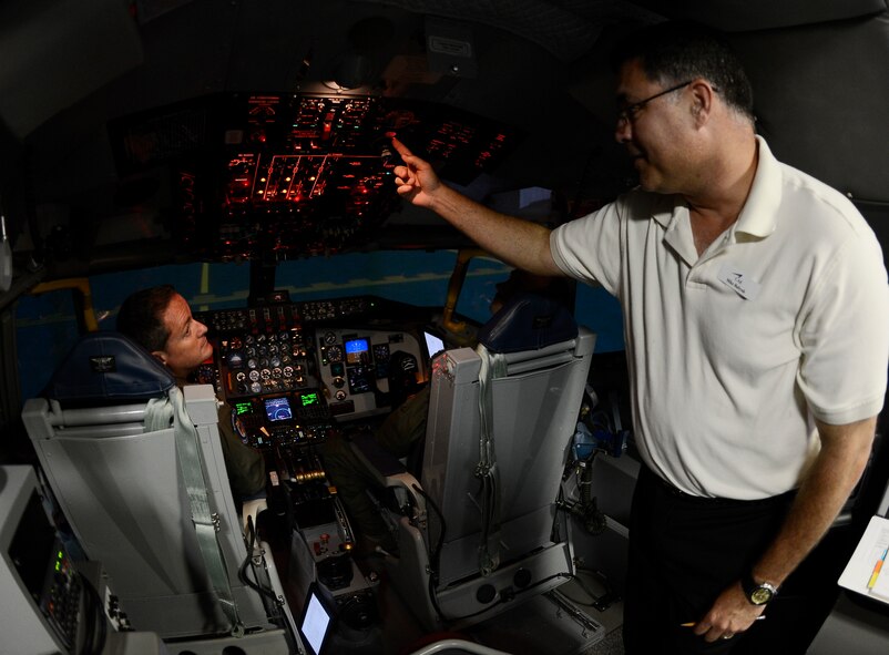 Mike Kirkner, Canadian Aviation Electronics representative, conducts a simulation training July 10, 2014 at MacDill Air Force Base, Florida. Pilots from the 63rd Air Refueling Squadron received windshear training to ensure that they are familiar with procedures during windshear conditions.(U.S. Air Force photo/Senior Airman Jenay Randolph)