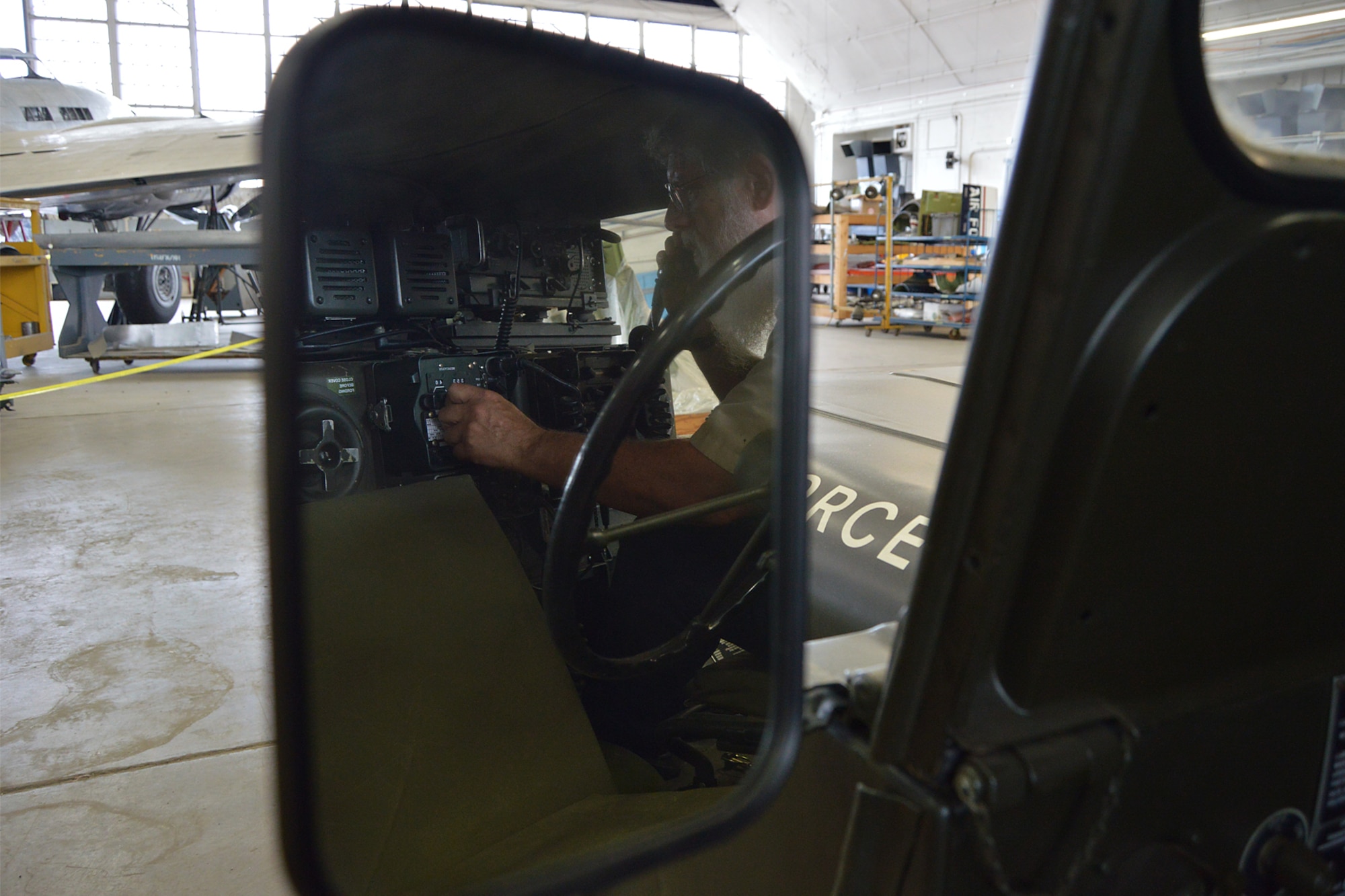 DAYTON, Ohio  -- Volunteer Larry Youngblood works on restoring the M151 Jeep. This vehicle was modified into a Forward Air Control (FAC) Jeep, which communicated with FAC aircraft to aid troops on the ground during the Southeast Asia War. Plans call for the Jeep to be displayed in the Southeast Asia War Gallery. (U.S. Air Force photo by Ken LaRock)