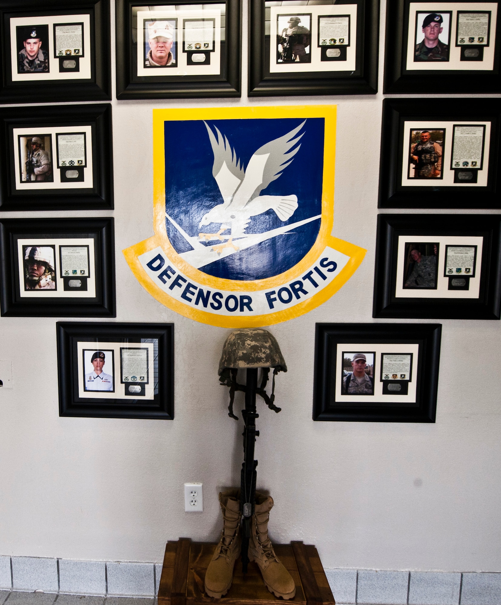 A fallen defender memorial wall is displayed in the entrance of the 1st Special Operations Security Forces building on Hurlburt Field Fla., June 25, 2014. The memorial honors Security Forces Airmen that have been killed in action since 9/11. (U.S. Air Force photo/Senior Airman Krystal M. Garrett)