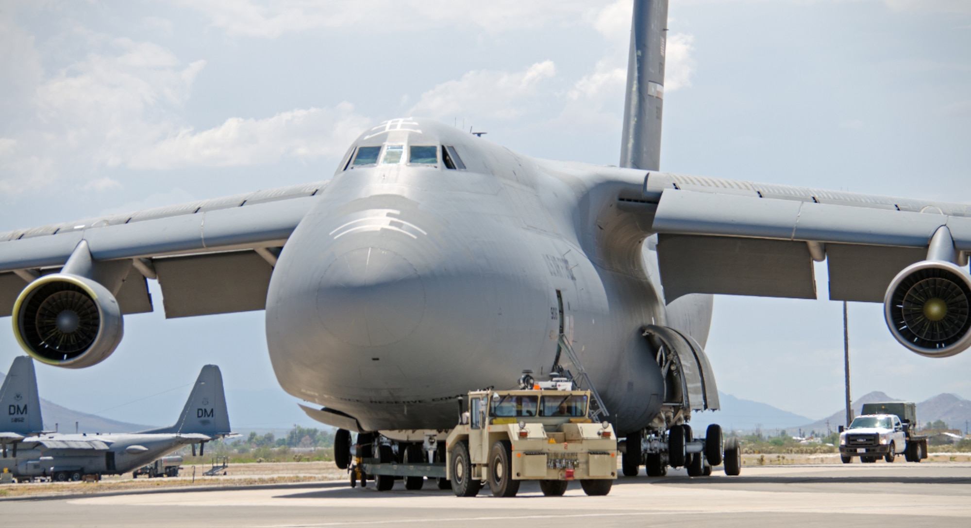 On its final voyage, a C-5A Galaxy aircraft, tail number, 90016 is being towed to its final resting place on the grounds of the 309th Aerospace Maintenance and Regeneration Group's storage and maintenance facility, Davis-Monthan Air Force Base, Arizona. The 433rd Airlift Wing's C-5A Galaxies are making way for the newer upgraded version of the aircraft, the C-5M Super Galaxy. (Courtesy Photo/Bill Sobeck)