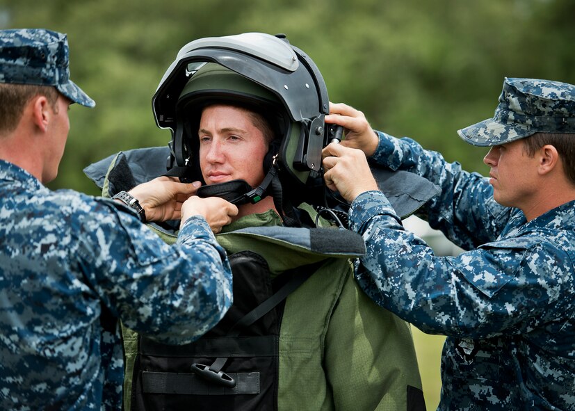 Navy explosive ordnance disposal students suit up their fellow Sailor in a bomb suit at Eglin Air Force Base, Fla.  After completing the standard DOD training course at Navy EOD school, Sailors attend the 55-day dive training on Eglin.  The Naval School EOD staff trains approximately 1,800 DOD military, civilian and international students annually.  (U.S. Air Force photo/Tech. Sgt. Samuel King Jr.)