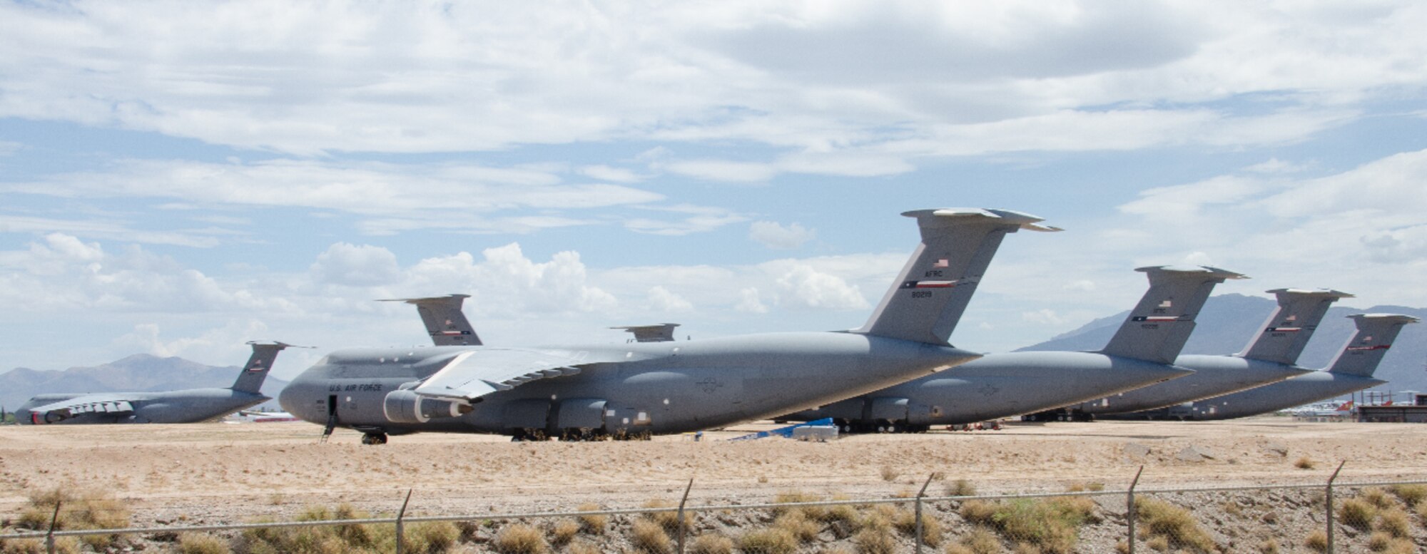 A C-5A from the 433rd Airlift Wing makes its final approach, July 9, 2014 to the 309th Aerospace Maintenance and Regeneration Group's storage and maintenance facility located on Davis-Monthan Air Force Base, Arizona. This C-5A, tail number 90016, is one of 23 aircraft that the Alamo Wing had in its inventory that are slowly being phased out to make way for the newer upgraded version of the aircraft, the C-5M Super Galaxy. (Courtesy Photo/Bill Sobeck)
