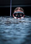 A Navy explosive ordnance disposal student surfaces from Weekly Bayou after a diving exercise at Eglin Air Force Base, Fla.  After completing the standard training course at Navy EOD school, Sailors attend the 55-day dive training on Eglin.  The Naval School EOD staff trains approximately 1,800 DOD military, civilian and international students annually.  (U.S. Air Force photo/Tech. Sgt. Samuel King Jr.)