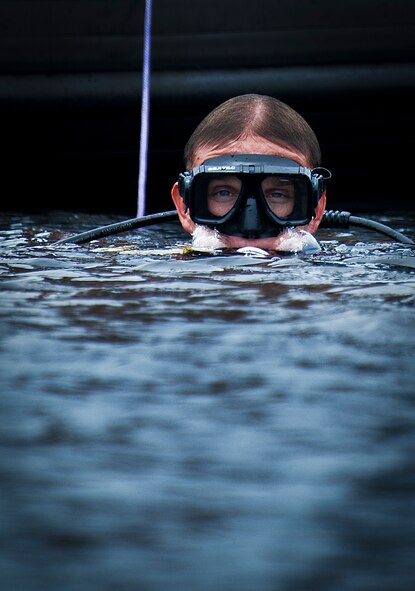 A Navy explosive ordnance disposal student surfaces from Weekly Bayou after a diving exercise at Eglin Air Force Base, Fla.  After completing the standard training course at Navy EOD school, Sailors attend the 55-day dive training on Eglin.  The Naval School EOD staff trains approximately 1,800 DOD military, civilian and international students annually.  (U.S. Air Force photo/Tech. Sgt. Samuel King Jr.)