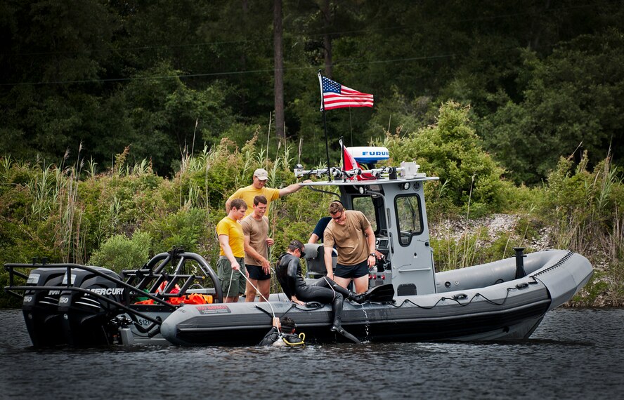 A Navy explosive ordnance disposal student climbs into a boat after a diving exercise in at Eglin Air Force Base, Fla.  After completing the standard training course at Navy EOD school, Sailors attend the 55-day dive training on Eglin.  The Naval School EOD staff trains approximately 1,800 DOD military, civilian and international students annually.  (U.S. Air Force photo/Tech. Sgt. Samuel King Jr.)