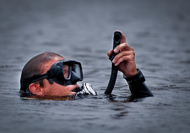 A Navy explosive ordnance disposal student surfaces from Weekly Bayou after a diving exercise at Eglin Air Force Base, Fla.  After completing the standard training course at Navy EOD school, Sailors attend the 55-day dive training on Eglin.  The Naval School EOD staff trains approximately 1,800 DOD military, civilian and international students annually.  (U.S. Air Force photo/Tech. Sgt. Samuel King Jr.)