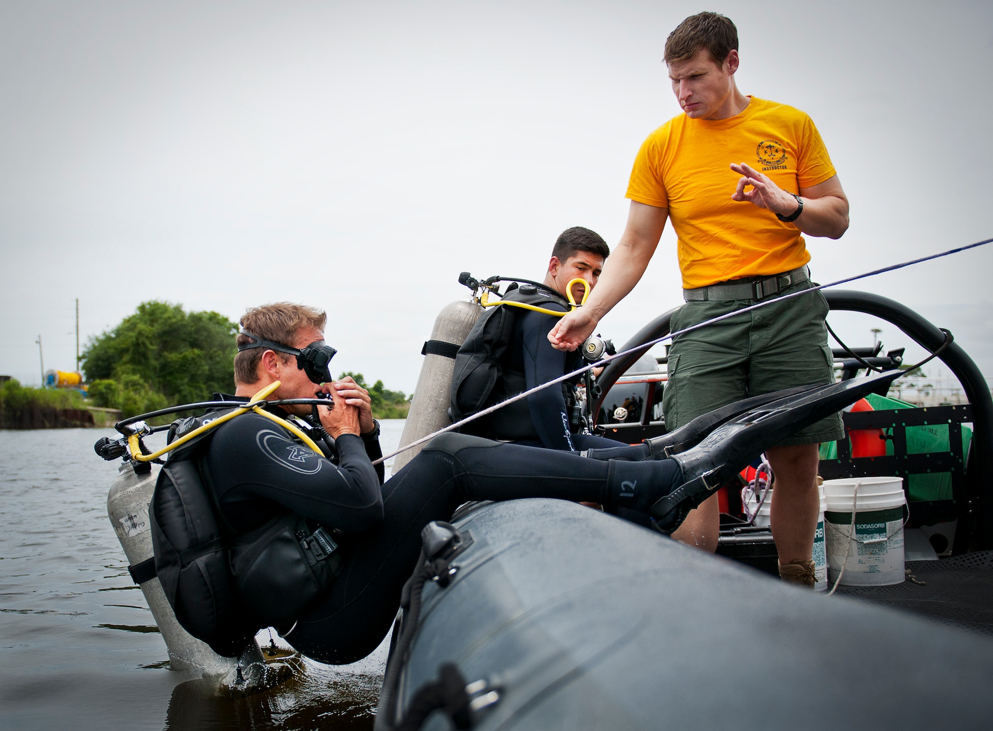 A Navy explosive ordnance disposal student enters the waters of Weekly Bayou during a diving exercise at Eglin Air Force Base, Fla.  After completing the standard training course at Navy EOD school, Sailors attend the 55-day dive training on Eglin.  The Naval School EOD staff trains approximately 1,800 DOD military, civilian and international students annually.  (U.S. Air Force photo/Tech. Sgt. Samuel King Jr.)