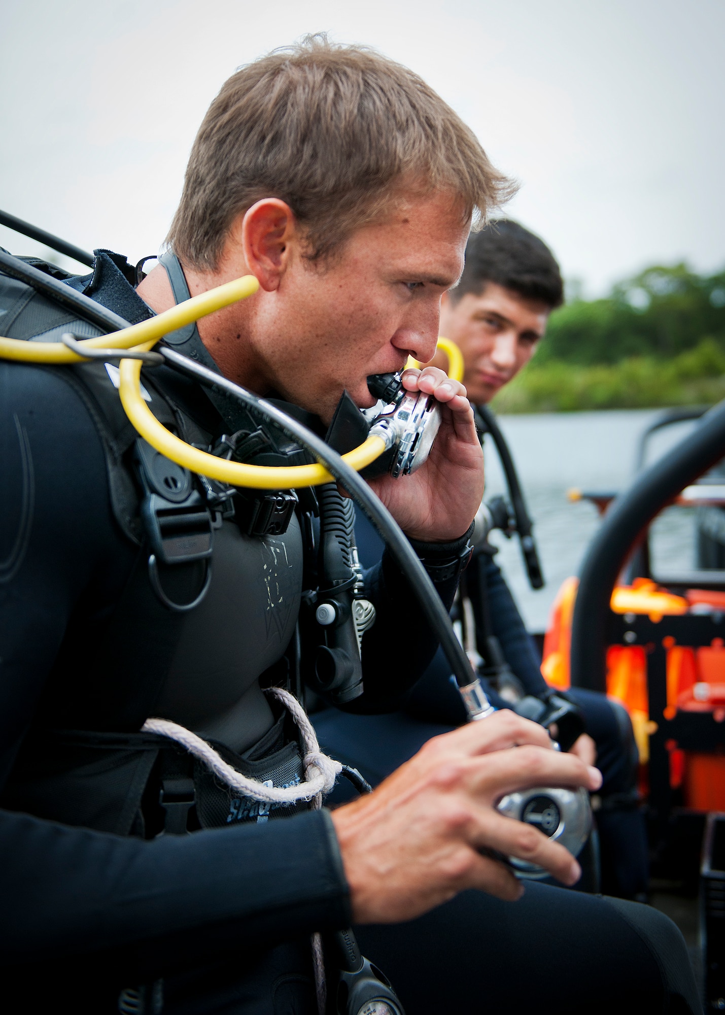 A Navy explosive ordnance disposal student checks his equipment before a diving exercise at Eglin Air Force Base, Fla.  After completing the standard training course at Navy EOD school, Sailors attend the 55-day dive training on Eglin.  The Naval School EOD staff trains approximately 1,800 DOD military, civilian and international students annually.  (U.S. Air Force photo/Tech. Sgt. Samuel King Jr.)