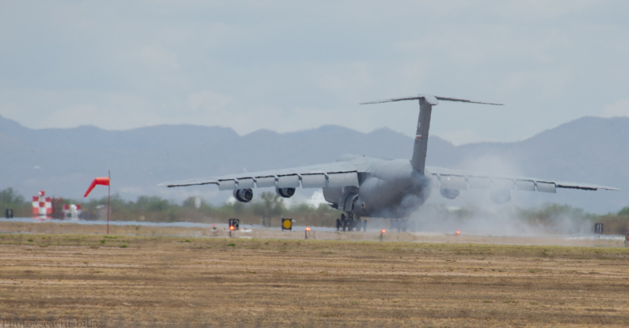 A C-5A from the 433rd Airlift Wing makes its final approach, July 9, 2014 to the 309th Aerospace Maintenance and Regeneration Group's storage and maintenance facility located on Davis-Monthan Air Force Base, Arizona. This C-5A, tail number 90016, is one of 23 aircraft that the Alamo Wing had in its inventory that are slowly being phased out to make way for the newer upgraded version of the aircraft, the C-5M Super Galaxy. (Courtesy Photo/Bill Sobeck)