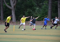 A pair of teams tee-off by kicking their soccer balls toward the green at the
Battle FootGolf at Wrenwoods Golf Course, July 11, 2014, at Joint Base Charleston, S.C. The Battle FootGolf was part of the monthly fitness challenge offered through
the Air Base Fitness & Sports Center and is expected to become an annual
event. FootGolf is a combination of soccer and golf where team members kick
a soccer ball into the marked holes on a golf course. (U.S. Air Force photo/Jessica
Donnelly)
