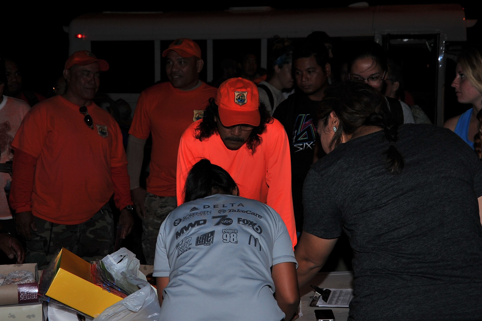 More than 100 volunteers gather before sunrise to receive their location assignment to monitor Mariana fruit bats flying around Andersen Air Force Base, Guam, July 3. The volunteers were assigned to 51 locations on the base during the early morning hours in hopes to sight the threatened species as they returned to their roosting spots for the daytime. (U.S. Air Force photo by Staff Sgt. Melissa B. White/Released)