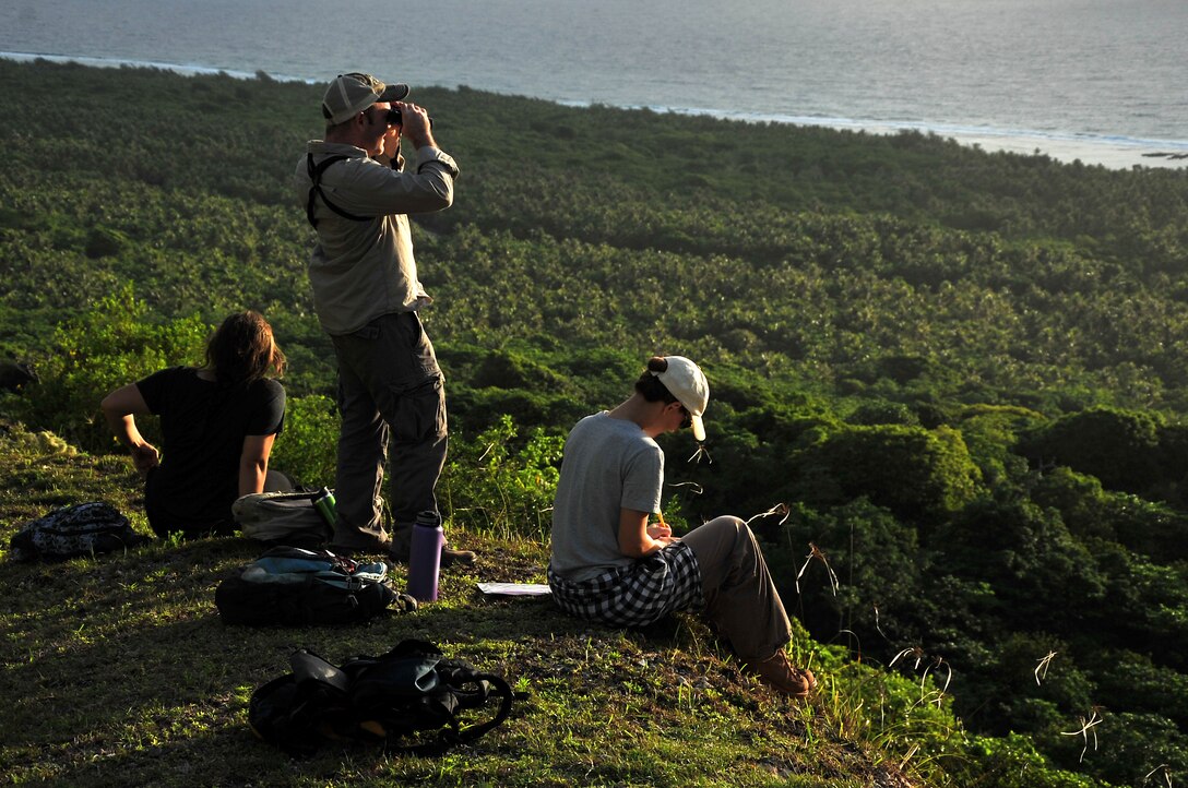 Josefa Muñoz, University of Guam biology major, Daniel McKay, UOG assistant professor, and Cacilie Craft, community volunteer, monitor Mariana fruit bats flying around the Tarague Basin on Andersen Air Force Base, Guam, July 3. More than 100 volunteers from the base and local community gathered for the first large-scale monitoring of the threatened species to help determine the population. (U.S. Air Force photo by Staff Sgt. Melissa B. White/Released)