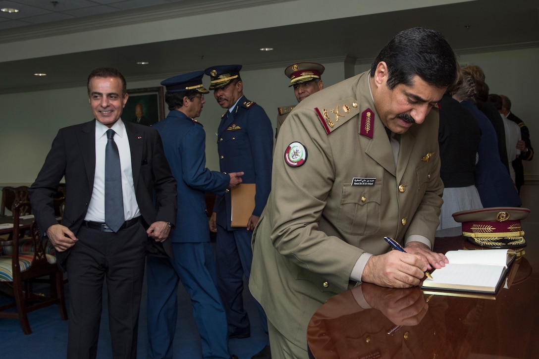 Hamad bin Ali al Attiyah, Qatari minister of state for defense affairs, signs the guest book before a meeting with U.S. Defense Secretary Chuck Hagel at the Pentagon, July 14, 2014. 