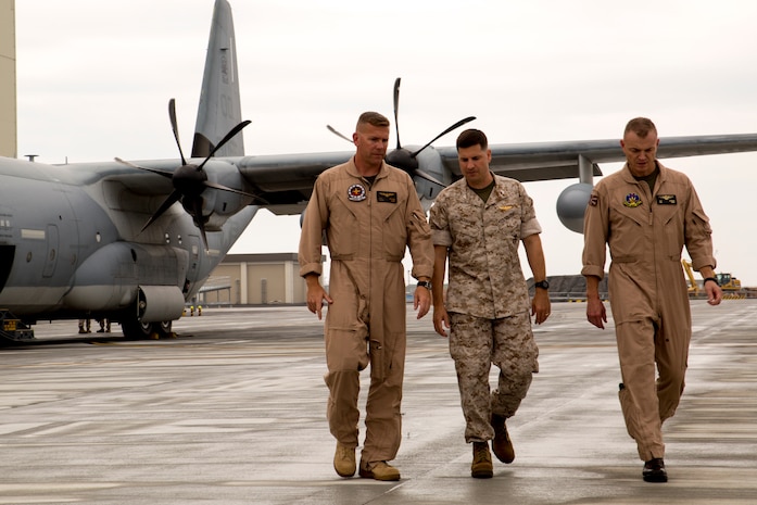 Lt. Col. Matthew W. Stover, commanding officer of Marine Aerial Refueler Transport Squadron 152, left, walks with Col. Robert V. Boucher, commanding officer of Marine Corps Air Station Iwakuni, Japan, middle, and Col. Hunter H. Hobson, commanding officer of Marine Aircraft Group 12 upon arriving at MCAS Iwakuni, July 15, 2014.Upon the KC-130J Super Hercules’ touchdown, administrative control of the squadron effectively changed from MCAS Futenma’s, based out of Okinawa, Japan, Marine Aircraft Group-36 to MAG-12 on Iwakuni. VMGR-152 will remain under operational control of III Marine Expeditionary Force in Okinawa, but MAG-12 will be in charge of providing the squadron with all the gear and supplies necessary in carrying out their missions.