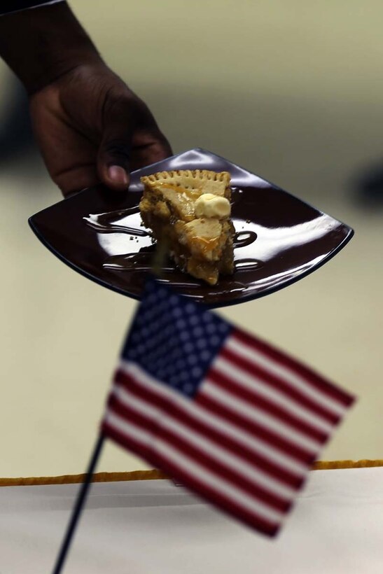 Corporal Alan Whitmore presents a slice of apple pie to the judges of the Chef of the Quarter competition at Marine Corps Air Station Cherry Point, N.C., July 11, 2014. The Chef of the quarter competition is a quarterly event for food service specialists at the Cherry Point Mess Hall. Whitmore is a food service specialist with Headquarters and Headquarters Squadron.