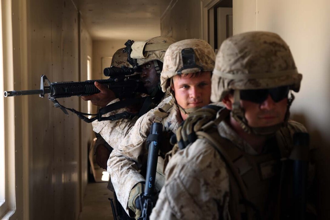 A team of Marines clear rooms in a mock hostile enemy compound during military operations on urban terrain training at Marine Corps Outlying Field Atlantic, N.C.,  July 7-11, 2014. The Marine focused on communication to ensure the training ran as smoothly as possible. The Marines are with 2nd Low Altitude Air Defense Battalion.