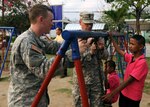 Army Sgt. Michael Raaf, a medical readiness noncommissioned officer, and Army Capt. Joshua Van Vlack, chaplain both with 2nd Battalion, 162nd Infantry Regiment, 41st Infantry Combat Brigade with Oregon National Guard, fix a swing set at the Ratchasima Boy's Home here Feb. 10, 2012. The Guard members are training at Camp Friendship in support of Cobra Gold 2012. Cobra Gold 2012 is the 31st iteration of the joint, multinational exercise held to enhance interoperability with participating nations and to advance security throughout the Asia-Pacific region.