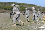 Soldiers in the 120th Infantry Brigade's 2nd Battalion, 393rd Infantry Regiment move toward their targets during a short-range marksmanship range at Fort Hood, Texas, Feb 7, 2012. The unit's primary mission is planning and resourcing culminating training events for Army National Guard and Reserve units deploying overseas. In between training units, "Dakota" battalion Soldiers maintain their basic infantryman skills.