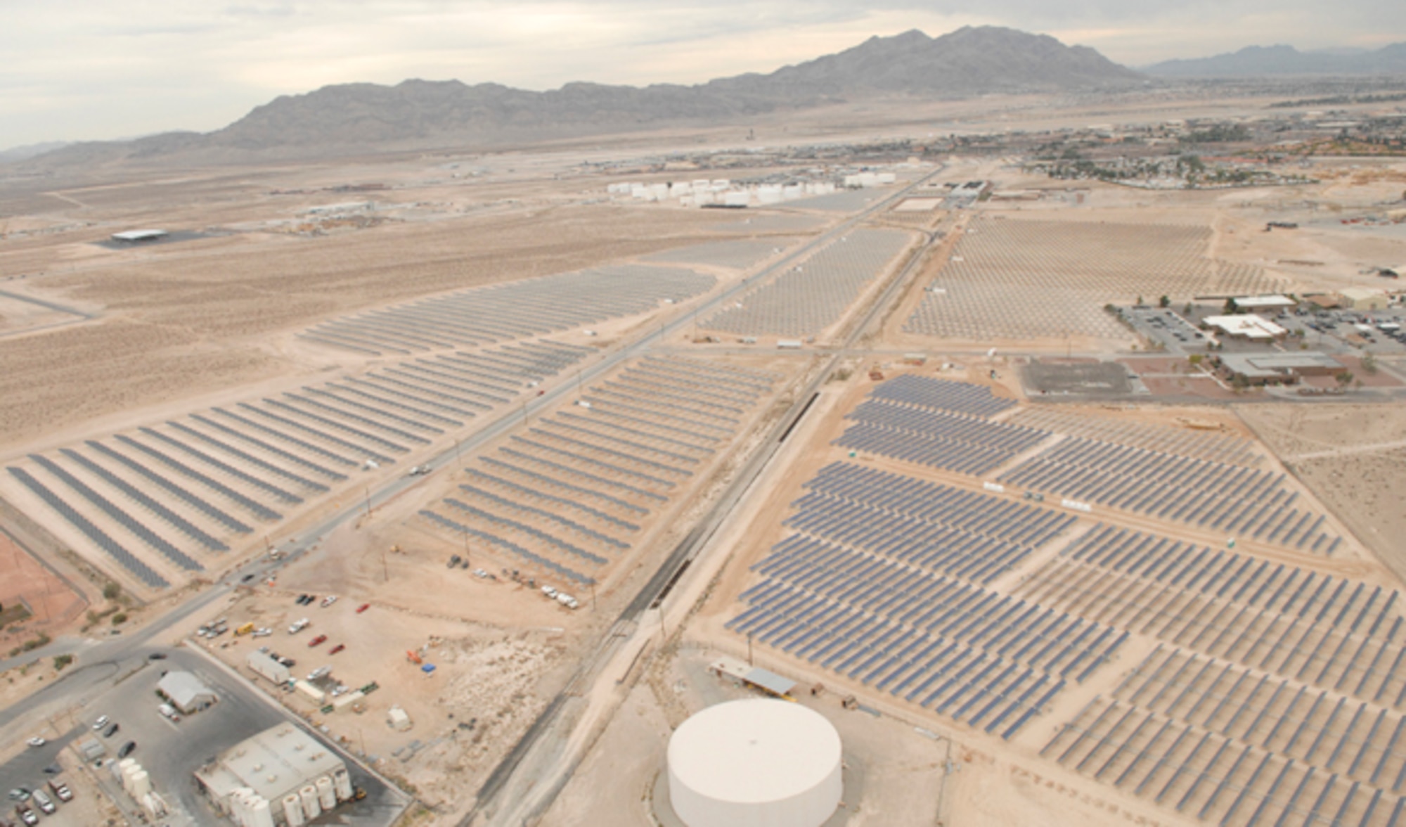 Nellis Air Force Base, Nev., plans to more than double its solar power production pictured here in 2007. Recently, Air Force officials signed a land lease with NV Energy, paving the way for construction of a 19-megawatt solar photovoltaic power system. NV Energy will provide a secondary substation and a transmission line as an in-kind consideration to the government for the lease. The substation will provide energy security and mission assurance by providing a redundant primary electric feed to the base. (U.S. Air Force photo)