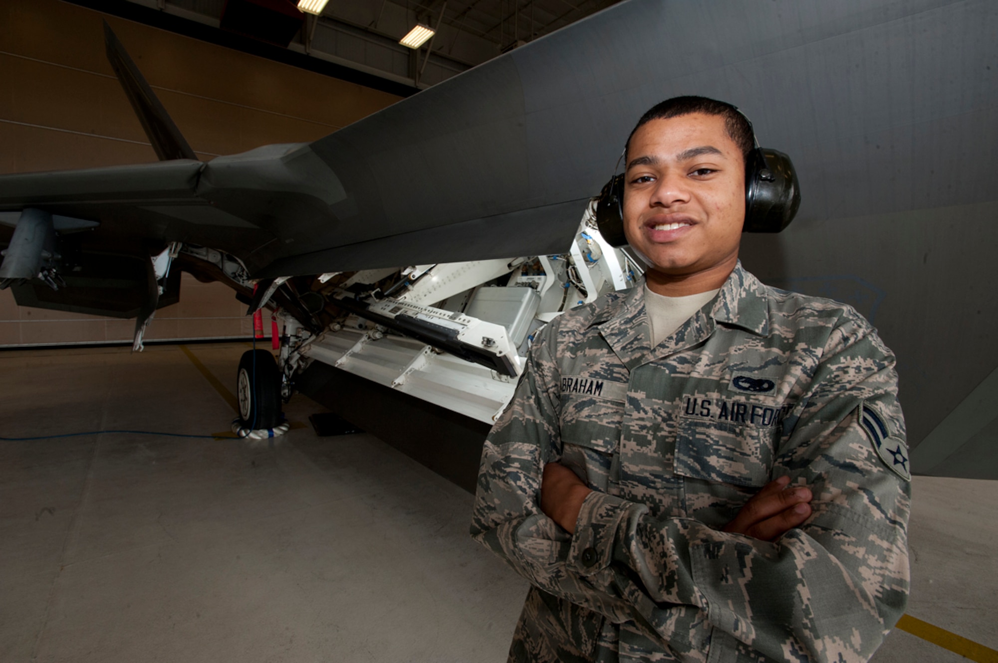 Airman 1st Class Kyron Abraham is an F-22 Raptor weapons specialist with the 3rd Aircraft Maintenance Squadron at Joint Base Elmendorf-Richardson, Alaska. Abraham is part of a three-man team that loads weapons onto the stealth fighters, and is a native of Reistertown, Md. (U.S. Air Force photo/Staff Sgt. Robert Barnett)