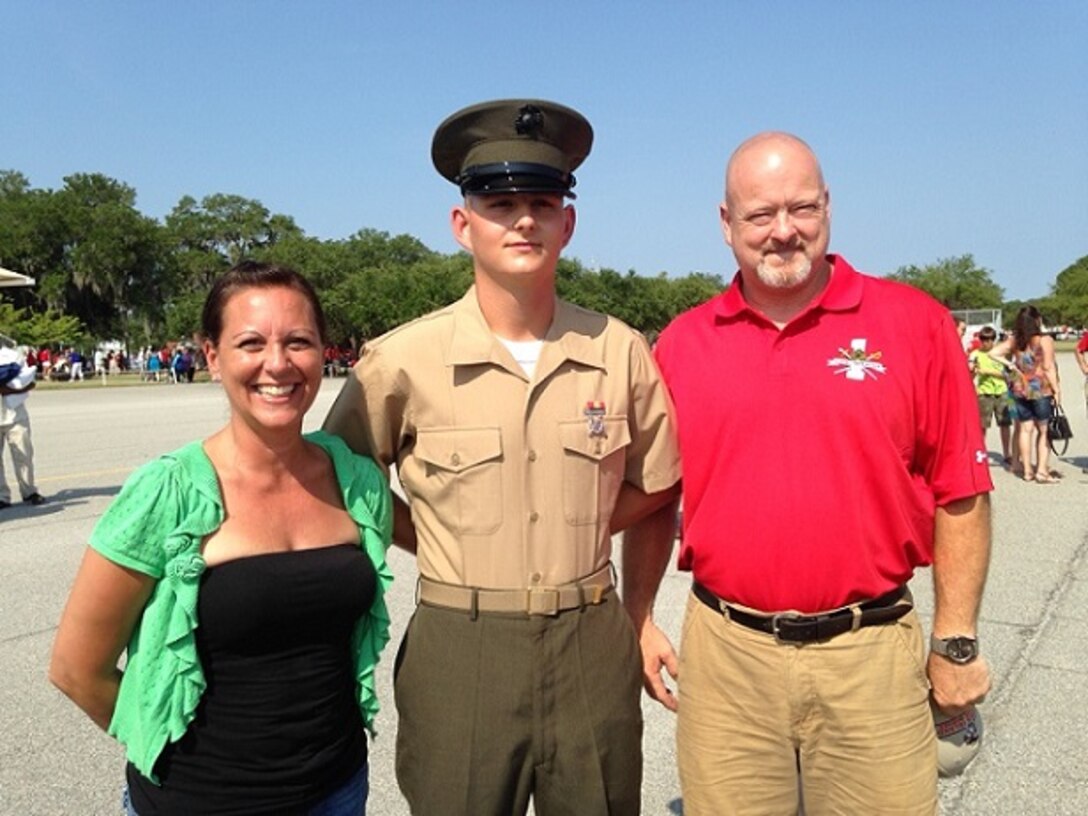Doreen Kostiuk, mom, Private Daniel Pritchett, recent graduate of Bravo Company, 1st Battalion, and Kenneth Pritchett, dad, pose for a family photo after Basic Training Graduation on June 20, 2014 at Marine Corps Recruit Depot Parris Island. Kostiuk and K. Pritchett were support of their son joining.