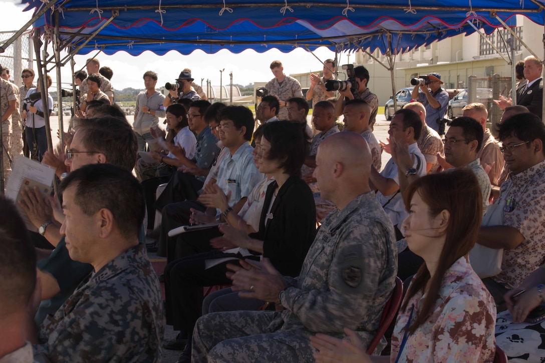 Members of an audience applaud July 15 at Marine Corps Air Station Futenma during Marine Aerial Refueler Transport Squadron 152’s take off ceremony. The ceremony commemorates the beginning of VMGR-152’s transfer to MCAS Iwakuni as part of the Marine Corps and Government of Japan’s bilateral effort to reduce impact to communities around MCAS Futenma, realign the presence and distribute the activities of U.S. forces in Japan. VMGR-152 is with Marine Aircraft Group 36, 1st Marine Aircraft Wing, III Marine Expeditionary Force. 