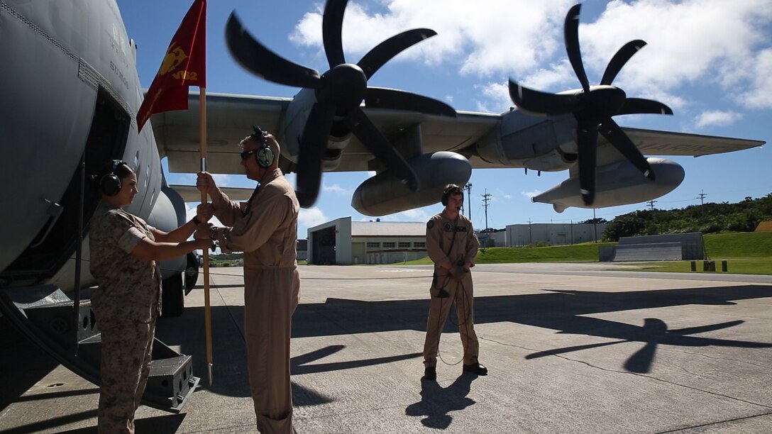 Lt. Col. Matthew W. Stover, center, is handed the guidon for Marine Aerial Refueler Transport Squadron 152 July 15 on Marine Corps Air Station Futenma during the squadron’s take off ceremony. Stover flew the guidon to the squadron’s new hanger at MCAS Iwakuni to officiate the move. Stover is the commanding officer of VMGR-152, Marine Aircraft Group 36, 1st Marine Aircraft Wing, III Marine Expeditionary Force. 