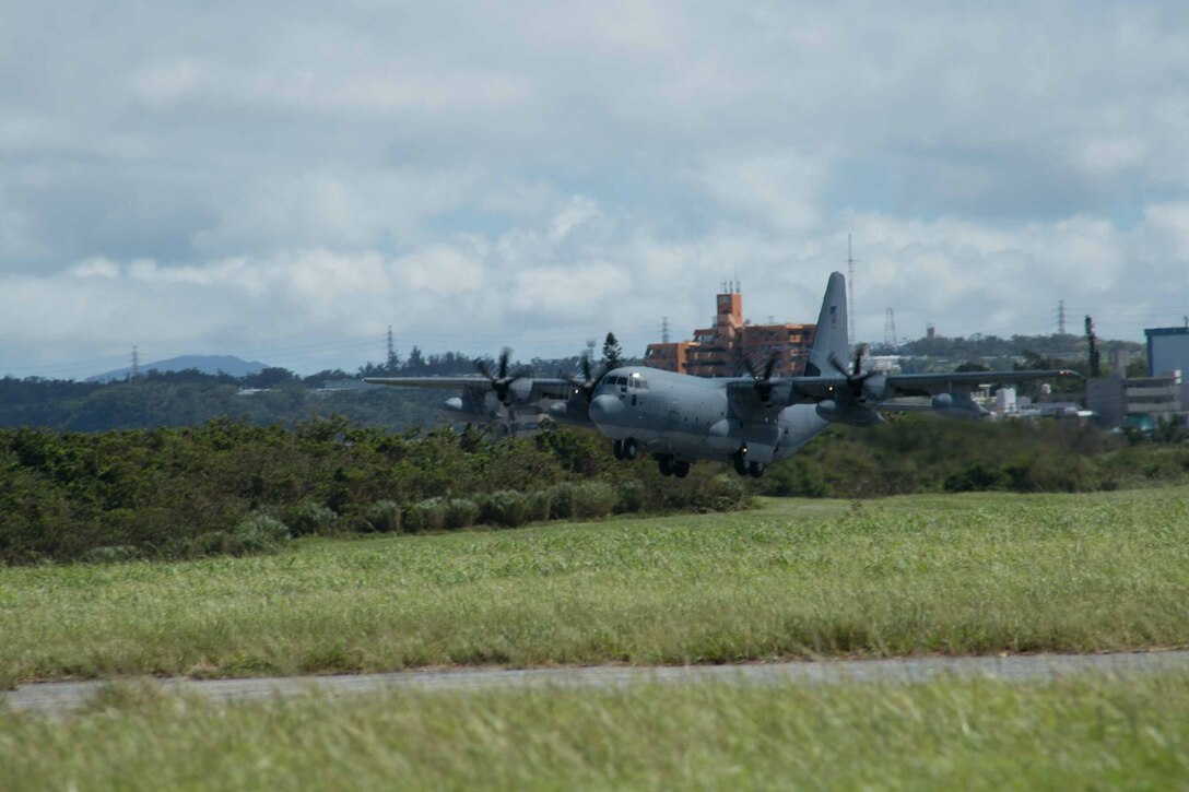 A KC-130J Super Hercules takes to the sky July 15 from Marine Corps Air Station Futenma during Marine Aerial Refueler Transport Squadron 152’s take off ceremony. The aircraft is the first to make the official flight to their new hangar on MCAS Iwakuni. VMGR-152 is with Marine Aircraft Group 36, 1st Marine Aircraft Wing, III Marine Expeditionary Force. (U.S. Marine Corps photo by Lance Cpl. Pete Sanders/Released)