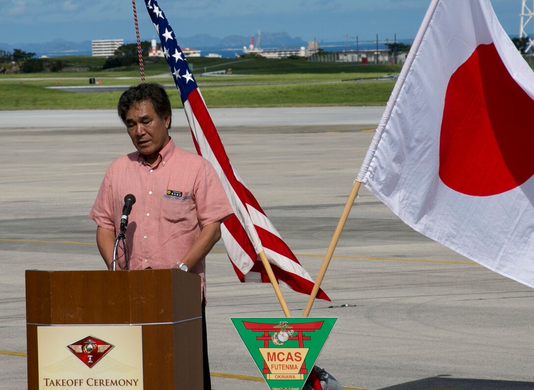 Vice Gov. Kurayoshi Takara addresses an audience July 15 on Marine Corps Air Station Futenma during Marine Aerial Refueler Transport Squadron 152’s take off ceremony. The ceremony commemorates the beginning of VMGR-152’s transfer to MCAS Iwakuni as part of the Marine Corps and Government of Japan’s bilateral effort to reduce impact to communities surrounding MCAS Futenma, realign the presence and distribute the activities of U.S. forces in Japan. Takara spoke about the long process that made the event possible. Takara is the vice governor of Okinawa prefecture. VMGR-152 is with Marine Aircraft Group 36, 1st Marine Aircraft Wing, III Marine Expeditionary Force. (U.S. Marine Corps photo by Lance Cpl. Pete Sanders/Released)