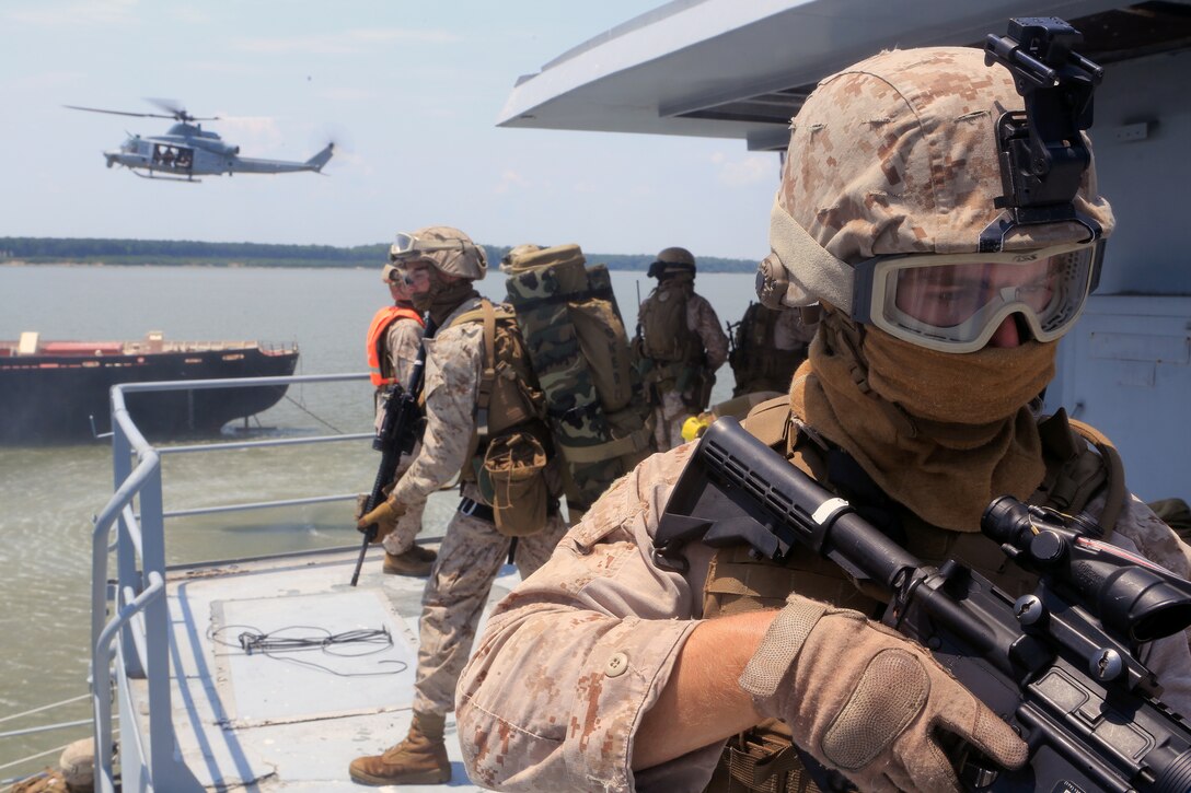A Maritime Raid Force Marine, 24th Marine Expeditionary Unit, provides security during a Visit, Board, Search and Seizure exercise as a part of Realistic Urban Training at Joint Base Langley-Eustis, Virginia, July 13, 2014. VBSS operations are primarily conducted by the Maritime Raid Force, a unit sourced from 2d Reconnaissance Battalion, for the purpose of Maritime Interdiction Operations.  RUT is the first major pre-deployment training exercise for the 24th MEU in preparation for their deployment.