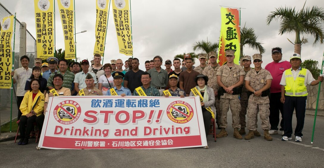 Kin Town community leaders, Marines with Camp Hansen and the Traffic Safety Association attended a traffic safety campaign July 1 near Gate 1 at Camp Hansen. The campaign was part of Operation Eye Catch, a mission to eradicate drunk driving in Okinawa. (U.S. Marine Corps photo by Lance Cpl. Tyler Ngiraswei/Released)