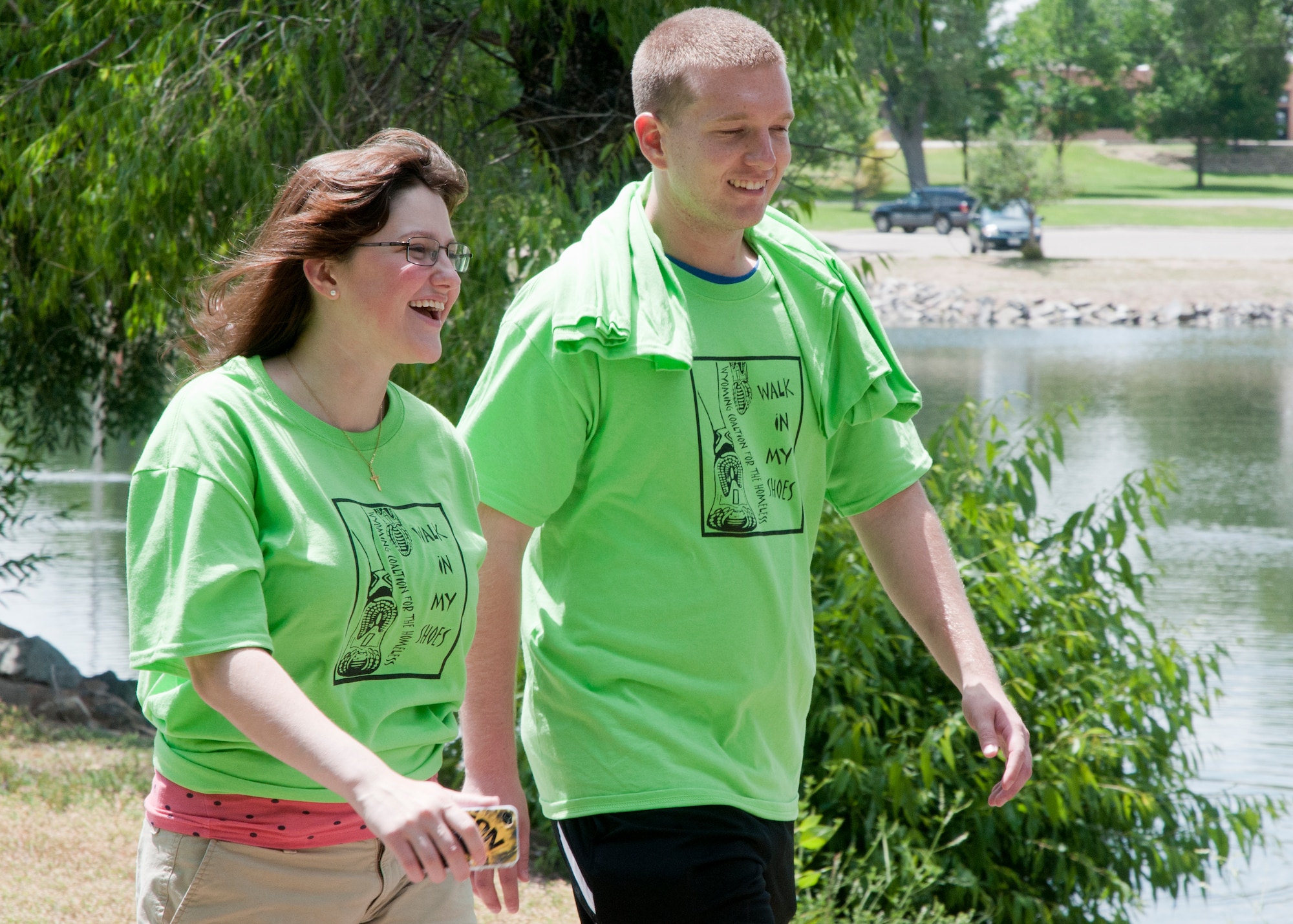 Airman 1st Class Siobhan Lynch, 90th Medical Operations Squadron, left, walks with Army Specialist Rory Flynn, 3rd Legal Operations Detachment, July 12, 2014 during the Walk in my shoes fundraiser. Lynch was sponsored by F.E. Warren Airmen’s counsel to participate in the fundraiser along with 12 others. The money raised goes to the Wyoming Coalition for the Homeless to help support those in need.