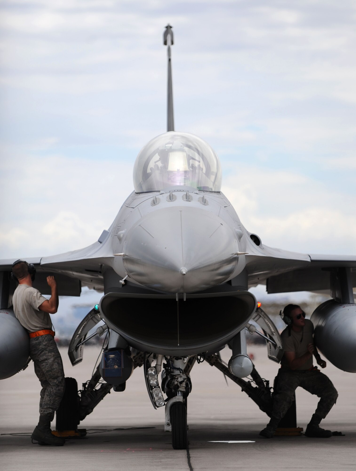 Airmen 1st Class Kevin Bozgoz, crew chief apprentice, and Gideon Warren, avionic specialist apprentice, 20th Fighter Wing, 79th Aircraft Maintenance Unit, Shaw Air Force Base, S.C., performs a final preflight prior to disconnecting communications during the kickoff of Red Flag 14-3 on Nellis AFB, Nev., July 14, 2014. Red Flag is a realistic combat training exercise involving the air forces of the U.S. and its allies and is being led this iteration by the 28th Bomb Wing from Ellsworth AFB, S.D. (U.S. Air Force photo by Tech. Sgt. Jerry Fleshman/Released)