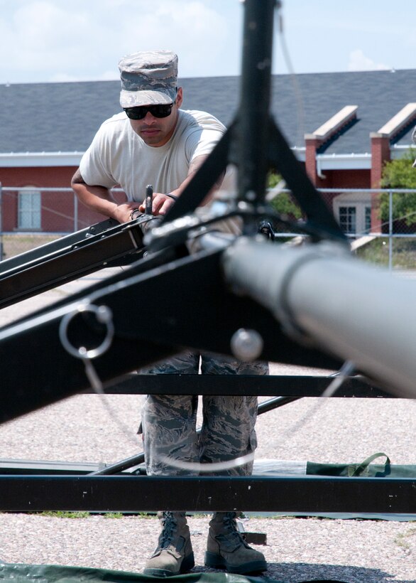 Staff Sgt. Julian Guerrero, 90th Civil Engineers Squadron, helps put together the frame of a tent July 14, 2014, in preparation for Fort DA Russell. Fort D.A. Russell Days is an event held every year as F.E. Warren Air Force Base’s open house.  (U.S. Air Force photo by Airman Malcolm Mayfield)