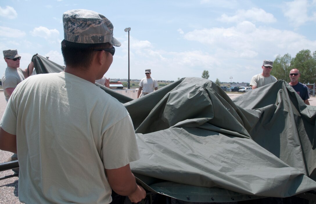 Airmen from the Civil Engineers Squadron finish up their last tent July 14, 2014 in preparation for Fort DA Russell. Tents placed prior to FDR are taken down after the event and moved to support the Cheyenne Frontier Days. (U.S. Air Force photo by Airman Malcolm Mayfield)