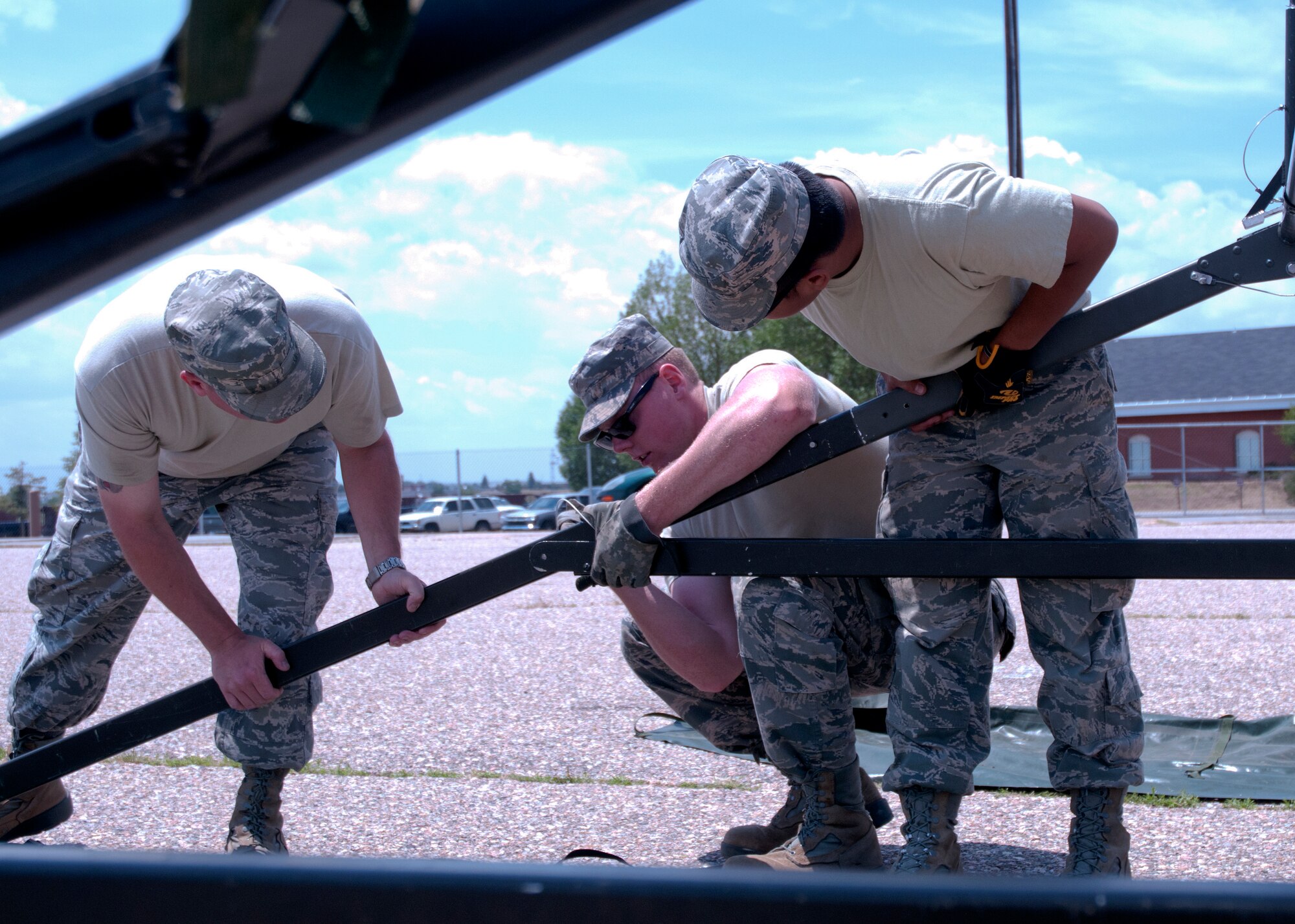 Airmen from the Civil Engineers Squadron finish up their last tent July 14, 2014 in preparation for Fort DA Russell. Tents placed prior to FDR are taken down after the event and moved to support the Air show. (U.S. Air Force photo by Airman Malcolm Mayfield)