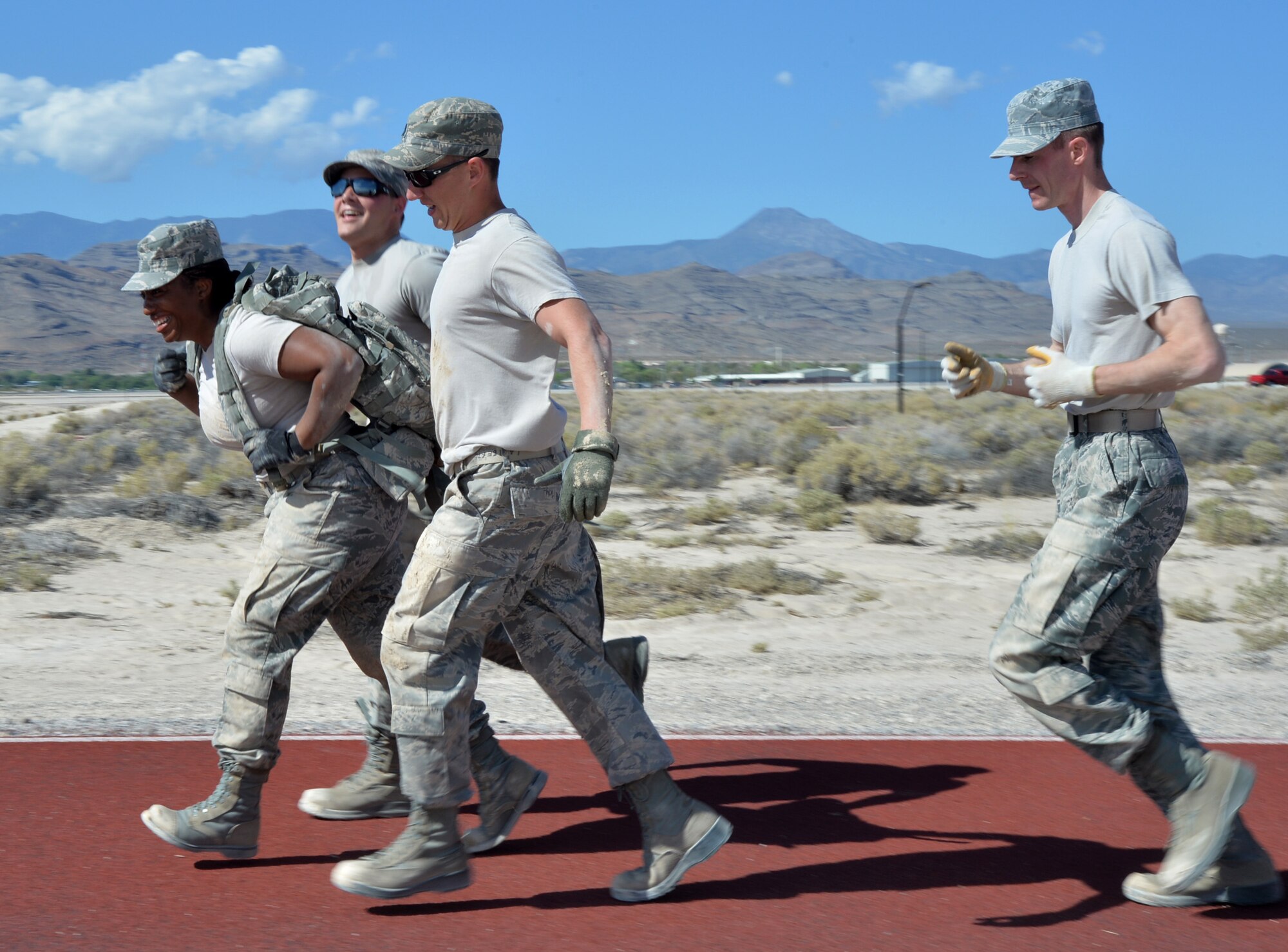 Airmen assigned to the 432nd Wing perform a team ruck march during the Combat Challenge July 11, 2014, at Creech Air Force Base, Nev. The Combat Challenge was part of the inaugural Creech Combat Dining-In and pitted teams from squadrons around the base against each other in a series of challenges to promote esprit de corps and camaraderie, while providing an opportunity for friendly competition. (U.S. Air Force photo by Tech. Sgt. Nadine Barclay/Released)