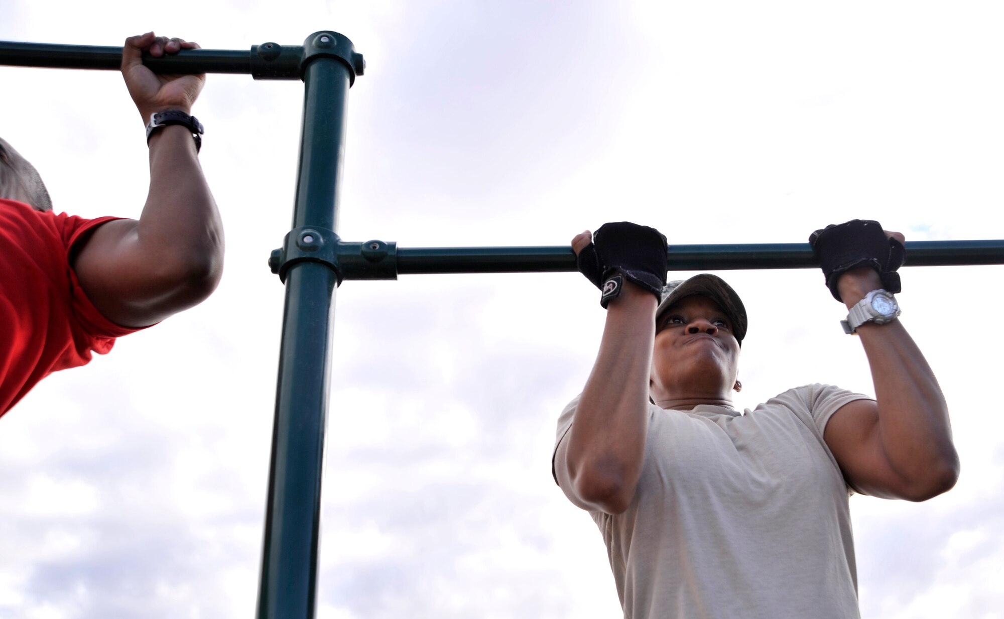 Master Sgt. Kiosha Mitchell, 432nd Wing Commanders Executive Administrations superintendent, performs pull-ups during the Combat Challenge July 11, 2014, at Creech Air Force Base, Nev. The Combat Challenge was part of the inaugural Creech Combat Dining-In and pitted teams from squadrons around the base against each other in a series of challenges to promote esprit de corps and camaraderie. (U.S. Air Force photo by Airman 1st Class Christian Clausen/Released)