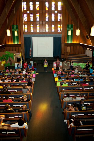 Parents and children assemble for vacation bible school inside the Nellis Air Force Base chapel July 14, 2014, at Nellis AFB, Nev. This year’s bible school consisted of religous studies, arts and crafts, snacks and games, which all followed an island theme. For more information on this or future vacation bible schools, call the base chapel at 702-652-2950. (U.S. Air Force photo by Senior Airman Timothy Young)