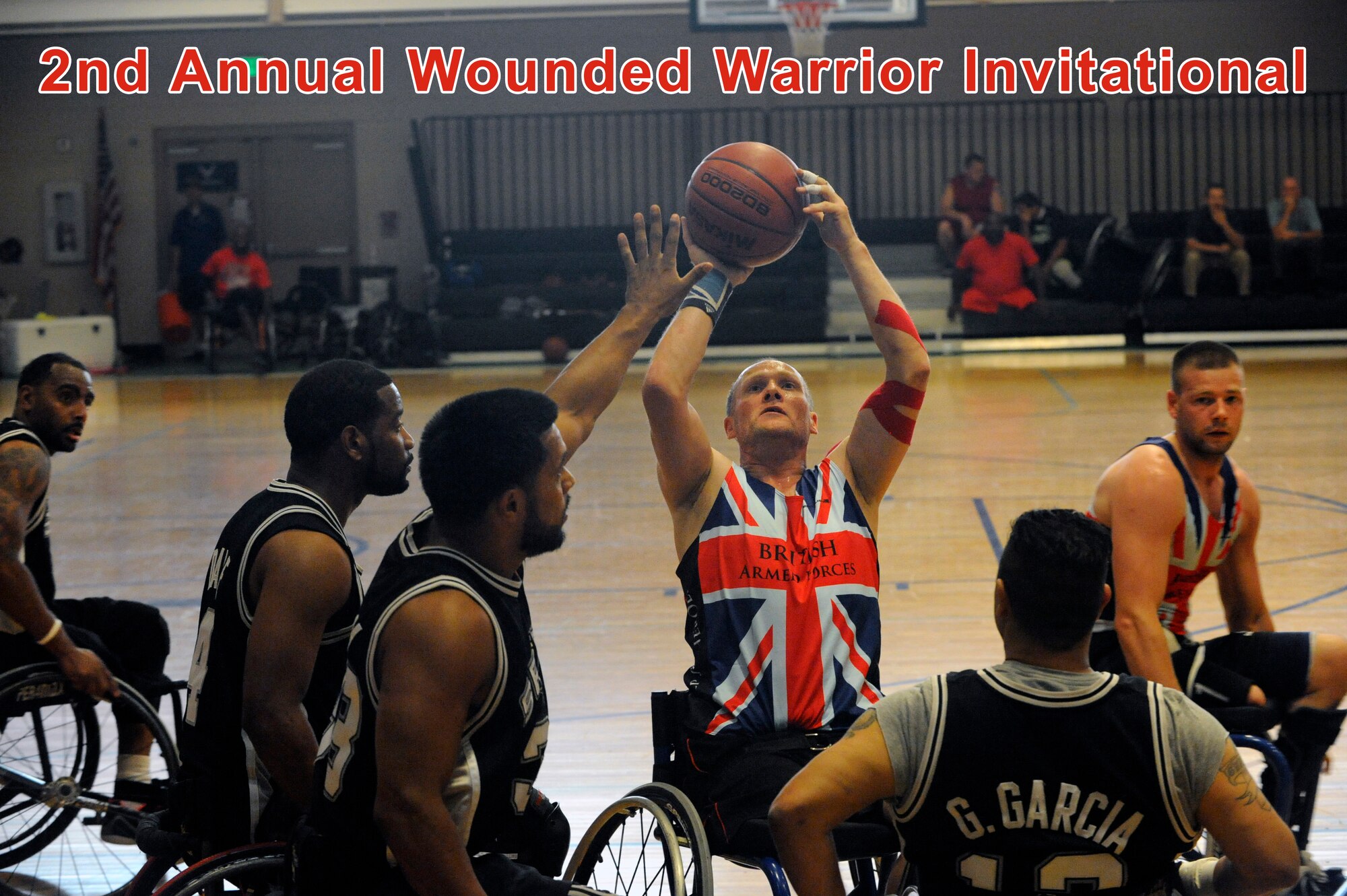 David Scott, center, shoots the basketball July 9, 2014, during 2014 Wounded Warrior Summer Invitational Adaptive Sports Tournament at the Rambler Fitness Center at Joint Base San Antonio-Randolph, Texas. The event features 100 wounded warriors from both the U.S. and the United Kingdom. The event is leading up to two other events beginning this September, which are the Warrior Games being held in Colorado Springs, Colorado, and the Invictus Games being held in the U.K. Scott is a player on the British Armed Forces team. The three-day event included skill development and tournament competition in wheelchair basketball and sitting volleyball for the wounded warriors from the U.S. Air Force, Army, Marine Corps and Great Britain. (U.S. Air Force photo/Desiree N. Palacios)
