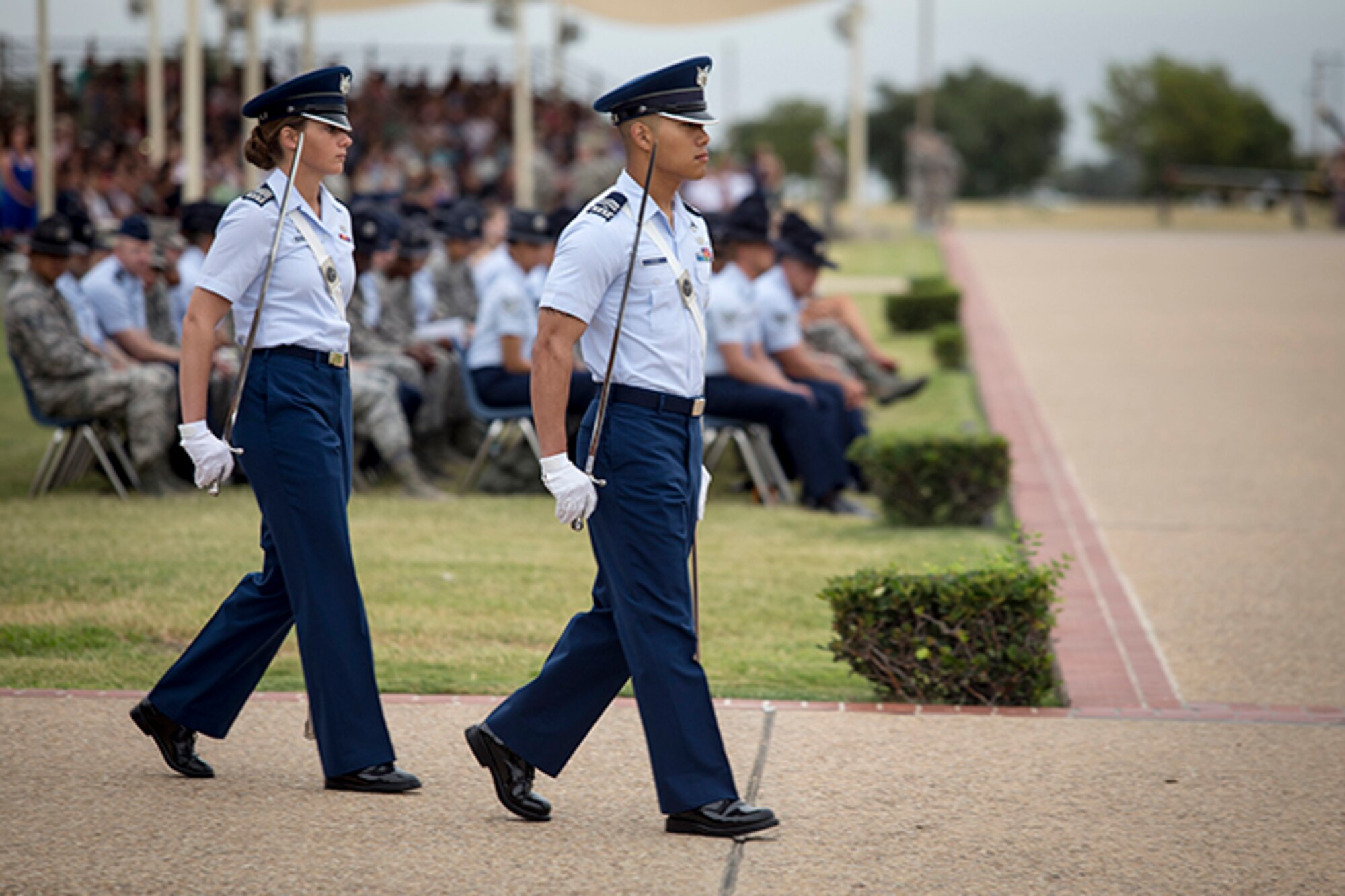 U.S. Air Force Academy Cadets 2nd Class Monica Kestermann (left) and Paul Yang get in position to lead the July 11 basic military training graduation parade at Joint Base San Antonio-Lackland. (U.S. Air Force photo/Joshua Rodriguez)